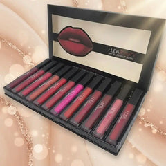 Set of Huda Beauty matte liquid lip glosses in a black box with a blurred background