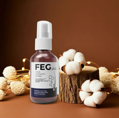 FEG plus hair growth spray bottle with cotton flowers on a brown background