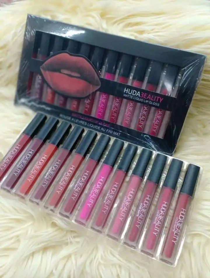 Set of Huda Beauty lipsticks with packaging on a textured surface online store seller in Pakistan