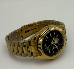 Gold watch with a black face on a light gray background