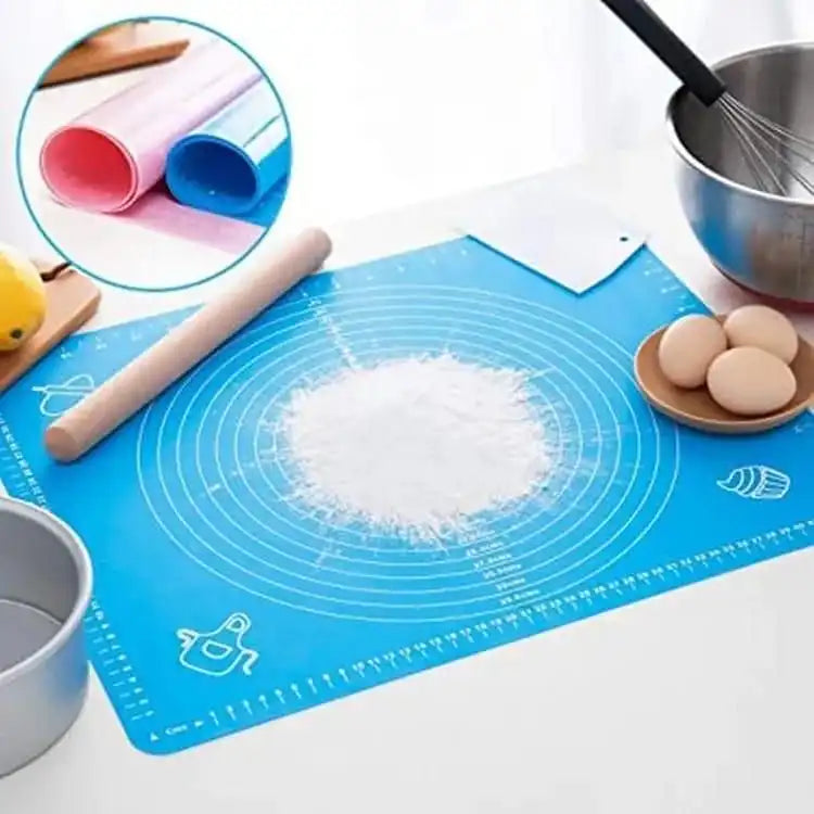 Baking setup with a blue silicone mat, rolling pin, bowl, and whisk on a white surface. Online Sale In Pakistan