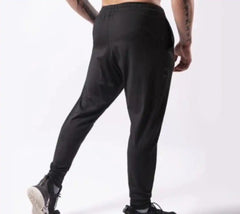 Person wearing black pants on a white background