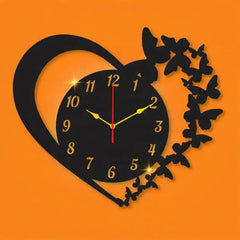 Decorative wall clock with heart and butterfly design on an orange background